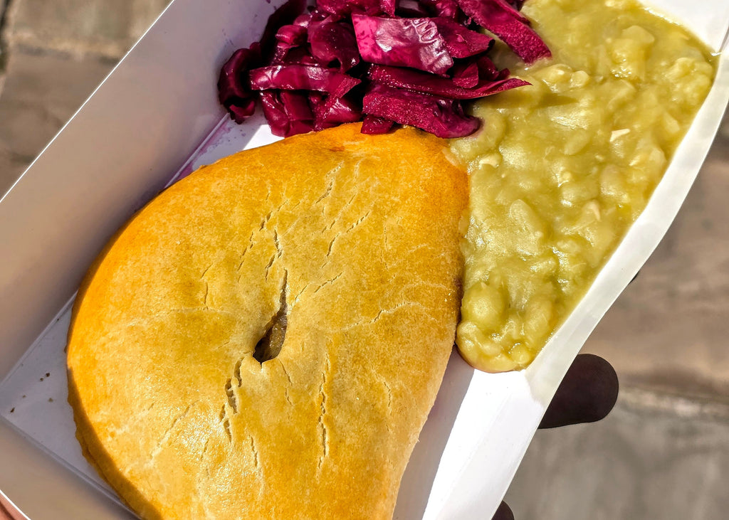 Tray of food with pasty, mushy peas and red cabbage 